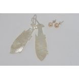 Pair long drop mother of pearl fish earrings with a pair of silver pearl earrings