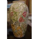 Moorcroft raised floral design porcelain vase green signature and factory marks to base, 31cm high