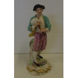 Antique German porcelain figure with bagpipes crossed Feather Mark, 22cm high.