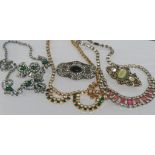 Quantity of costume jewellery including 3 necklaces, two brooches and a pair of lip earrings