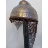 A C19th Indian military steel Helmet with engraved border decoration and chainmail neck guard. H47cm