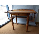 A Victorian satinwood writing table with pierced gallery above single draw united by undertier