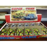 A collection of 12 wind up toy Super 135 tanks in trade box. 6 silver tanks and 6 camoflage