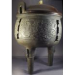 A large Chinese Ming Style C19th Archaic designed bronze tripod censer with allover cast cloud