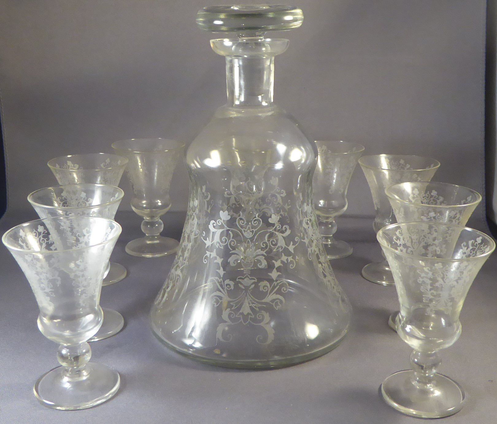 A set of 9 C19th port/sherry glasses , the repeating foliate etched sides on flared rim H 7.5cm