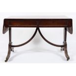 A Regency mahogany sofa table:, the hinged top with rounded corners,