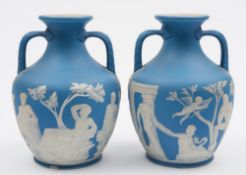 A pair of Wedgwood pale blue jasper ware 'Portland' vases: of typical two handled form decorated in