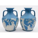 A pair of Wedgwood pale blue jasper ware 'Portland' vases: of typical two handled form decorated in