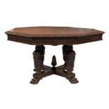 A Victorian carved oak octagonal library table:, the top with a gadrooned edge,