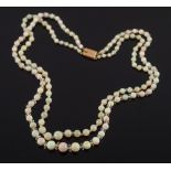 A graduated opal bead two string necklace:, the opals graduating from 4mm diameter to 9mm diameter,