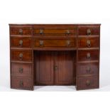 A Regency mahogany and inlaid bow-fronted enclosed kneehole washstand:, bordered with ebony lines,