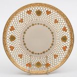 A Royal Worcester reticulated porcelain plate: of circular form with honeycomb piercing applied