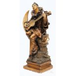 An Art Deco period painted plaster figure of Pierrot:  playing a guitar seated on a crescent moon