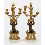 A pair of late 19th century bronze gilt brass and marble three branch garnitures: with urn shaped