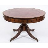 A Regency mahogany and inlaid circular drum top library table:, bordered with ebony lines,