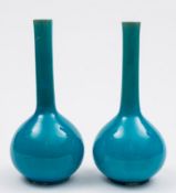 A pair of Chinese turquoise-glazed bottle vases: each with long slender neck and covered with a