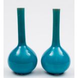 A pair of Chinese turquoise-glazed bottle vases: each with long slender neck and covered with a