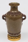 A Chinese dark celadon crackle glazed vase: of baluster form with faux bronze mask head handles and