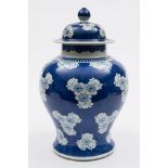 A Chinese blue and white baluster vase and cover: painted with prunus blossom on a cracked ice