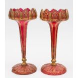 A pair of ruby glass table lustres: each with petal rim on an octagonal stem and circular foot cut