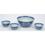 A Chinese porcelain bowl and three smaller: each painted in blue to the interior and exterior with