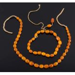 Two short, single-strings of small, amber coloured beads:, 19gms gross weight.