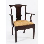 A George II mahogany elbow chair:, the back with serpentine top rail and solid central splat,