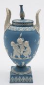 A Wedgwood pale blue jasper ware two-handled urn and cover: decorated in high relief with