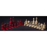 A 19th century bone Barleycorn style chess set: one side stained red, the other  left natural,