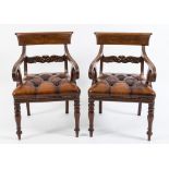 A pair of Regency carved mahogany elbow chairs:,