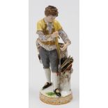 A Meissen porcelain figure of a gardener: modelled after the original by Victor Michael Acier,