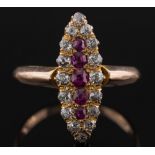 A gold, ruby and diamond marquise shaped cluster ring: the central, single row of graduated rubies,