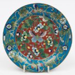 A Chinese cloisonne dish: the centre decorated with a butterfly amongst flowers to an iron red