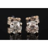 A pair of diamond single stone ear studs: with circular,