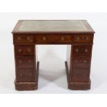 A Victorian mahogany pedestal desk:, the top inset with a panel of tooled leather,