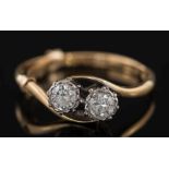 A diamond two-stone cross over ring: with circular, brilliant-cut diamonds,