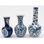 A Chinese blue and white bottle vase and two similar baluster vases: the first painted with two