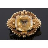 A mid 20th century gold and yellow sapphire single-stone brooch:,