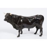 After Bayre, a bronze study of a bull: it's head turned slightly left, with inset ivory horns, 35cm.