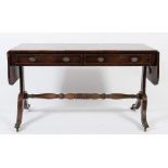 A Regency mahogany sofa table:, the hinged top with rounded corners,