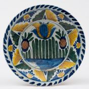 A Bristol delft blue dash tulip charger: painted in yellow, green,