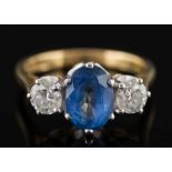 An 18ct gold, sapphire and diamond three-stone ring:,