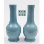 A pair of Chinese claire-de-lune glazed bottle vases: each with cylindrical neck and on spreading