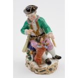 A Meissen porcelain figure group: modelled as a seated lad holding a hoop for a performing dog