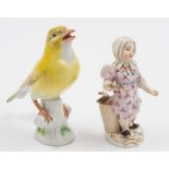 A Meissen figure of a Canary and a figure of a cherub fish seller: the canary on tree stump base,