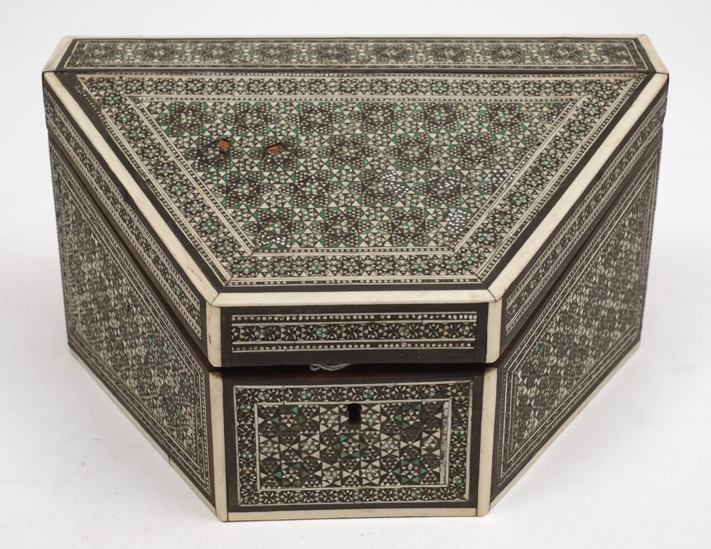 A Persian ivory and ebony inlaid stationery box: the sloping hinged lid enclosing a fitted slatted