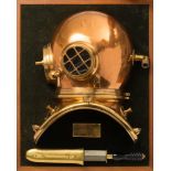 A display mounted half section 6-bolt 'Pearler' diving helmet and diver's knife by Siebe Gorman &