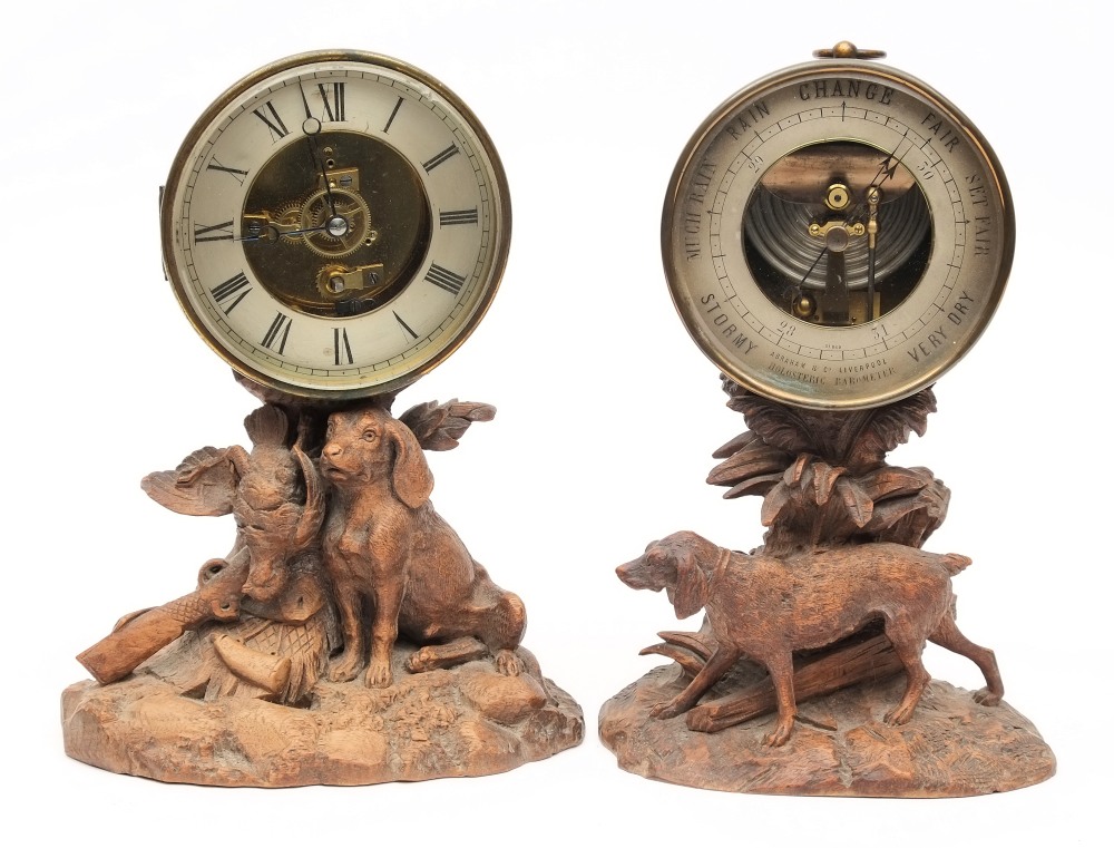 A 19th century Black Forest carved clock and barometer set:, the clock with visible escapement,