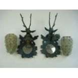 A pair of brass stag's head wall lights with floral pattern glass shades:, .