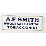 An early 20th century enamel advertising sign for 'A F Smith - Wholesale & Retail Tobacconists':,